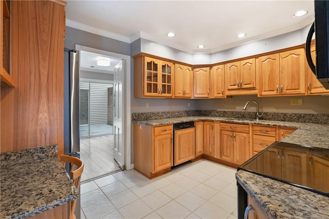 kitchen featuring glass insert cabinets, ornamental molding, stone counters, black appliances, and a sink