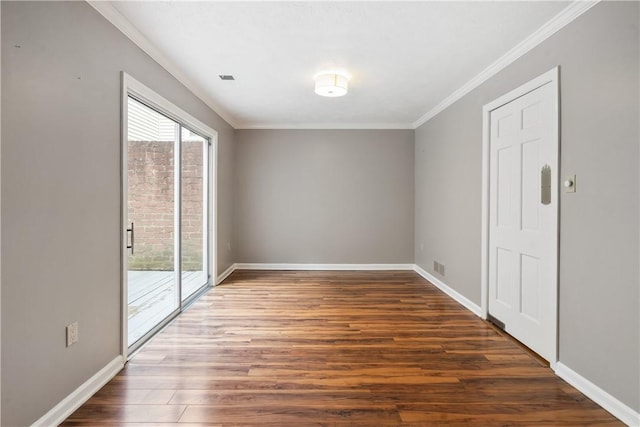 spare room with baseboards, a healthy amount of sunlight, wood finished floors, and ornamental molding