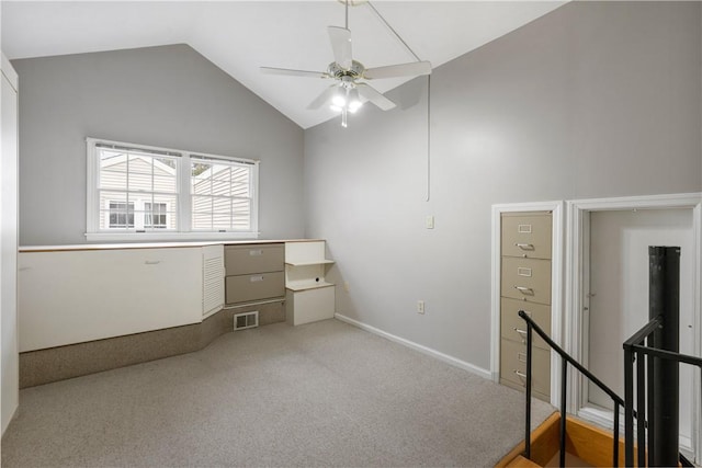 interior space with visible vents, baseboards, ceiling fan, and vaulted ceiling