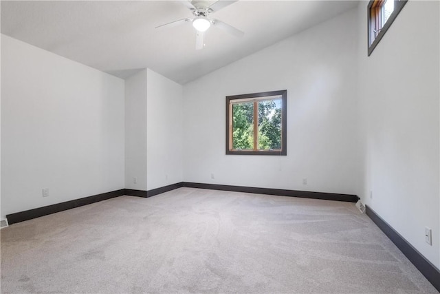 unfurnished room featuring light carpet, ceiling fan, lofted ceiling, and baseboards