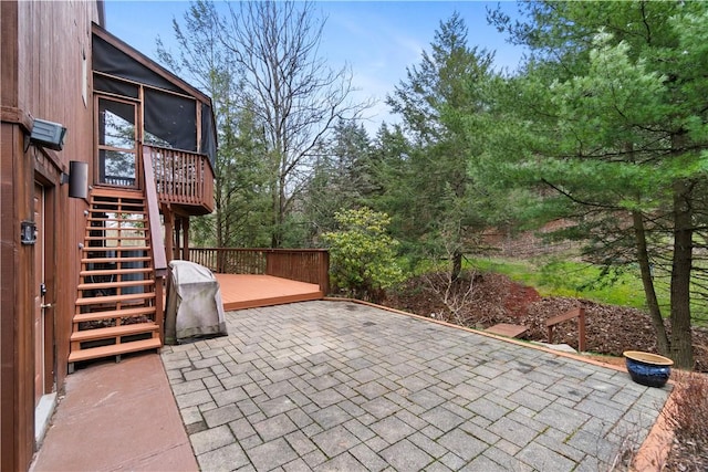 view of patio featuring a sunroom, stairs, and a deck