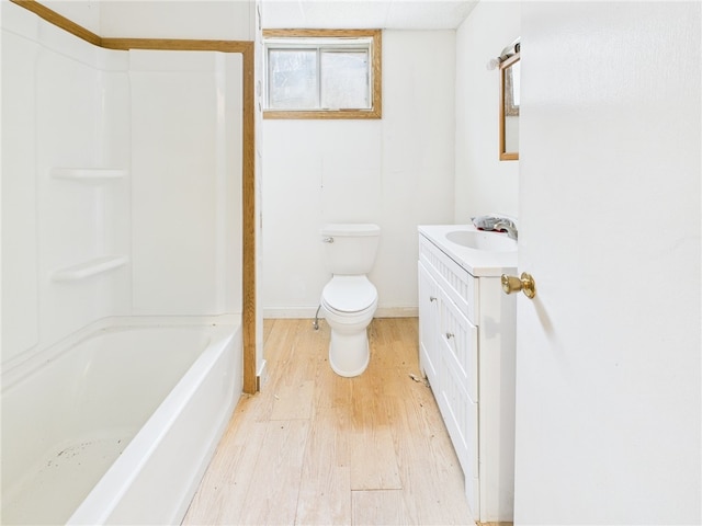 full bath with baseboards, vanity, toilet, and wood finished floors