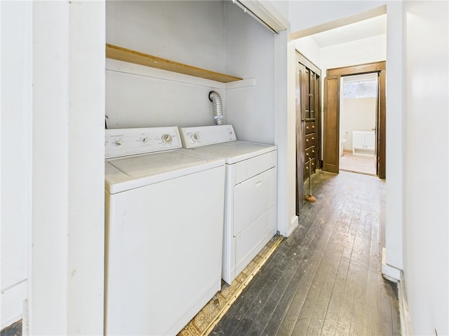 laundry area with washer and dryer, laundry area, and wood-type flooring