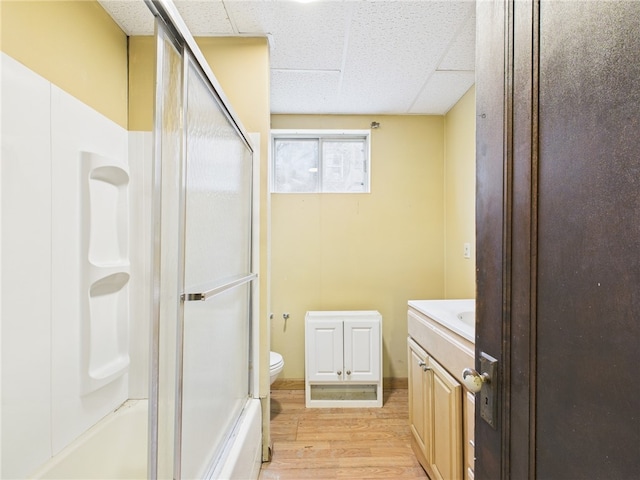 bathroom featuring a drop ceiling, vanity, toilet, and wood finished floors