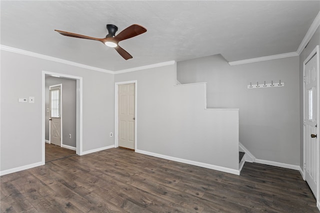 empty room with ornamental molding, dark wood finished floors, baseboards, and ceiling fan