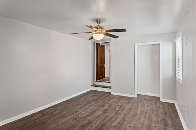 interior space with dark wood-style floors, a closet, baseboards, and a ceiling fan