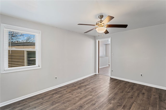 spare room with ceiling fan, baseboards, and wood finished floors