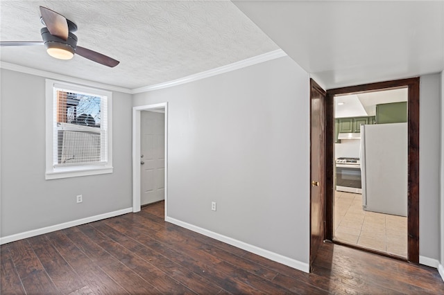 interior space with a textured ceiling, baseboards, and hardwood / wood-style flooring