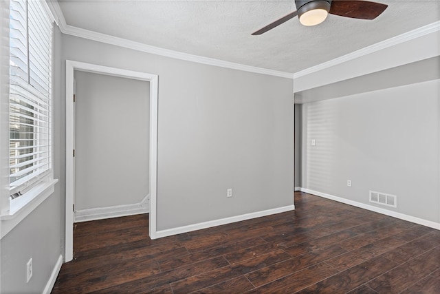 spare room with a ceiling fan, wood-type flooring, visible vents, and crown molding