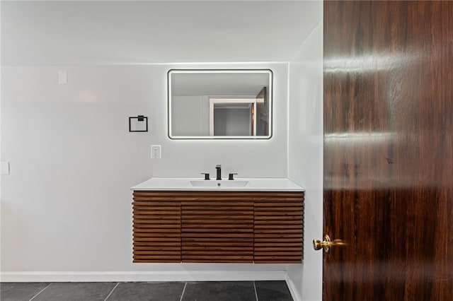 bathroom with tile patterned flooring, vanity, and baseboards