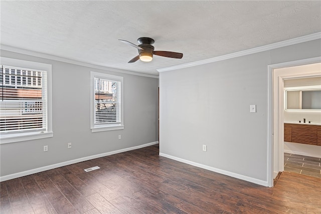 unfurnished bedroom with baseboards, ornamental molding, and wood finished floors