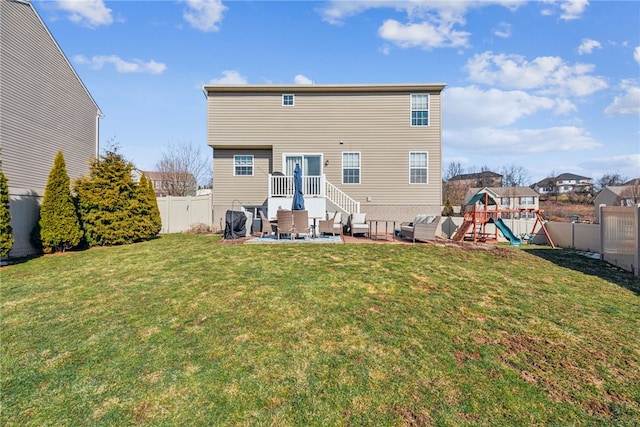 rear view of house with a playground, a patio, a fenced backyard, and a lawn