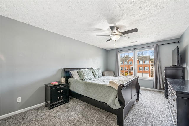 bedroom with a ceiling fan, light carpet, visible vents, and baseboards