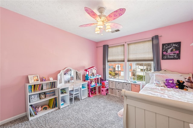 bedroom featuring baseboards, visible vents, a ceiling fan, a textured ceiling, and carpet flooring