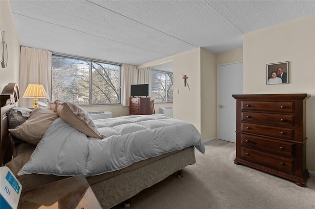 bedroom with carpet floors, a textured ceiling, and baseboards