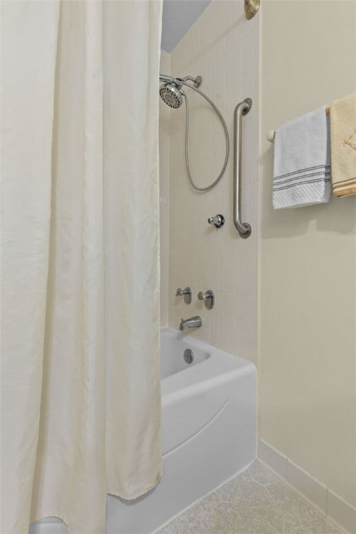 full bathroom featuring baseboards and shower / bath combo with shower curtain