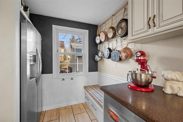 mudroom featuring a wainscoted wall and light wood-style flooring