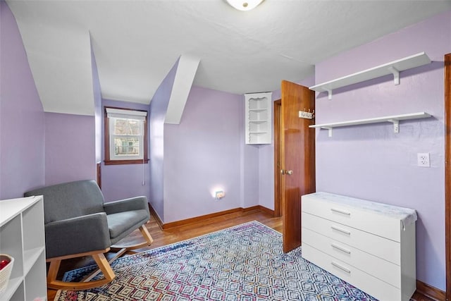 living area with wood finished floors and baseboards