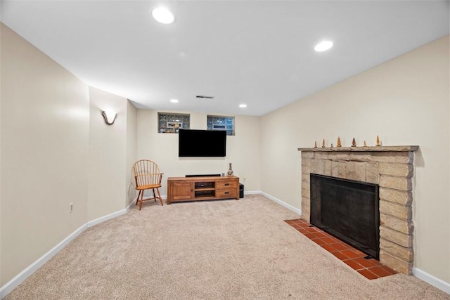 carpeted living area with a fireplace with flush hearth, visible vents, baseboards, and recessed lighting