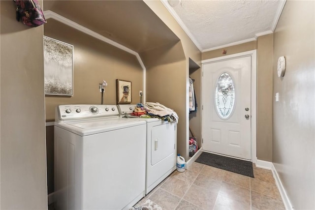 clothes washing area featuring a textured ceiling, laundry area, separate washer and dryer, baseboards, and crown molding