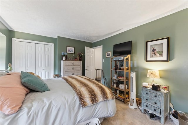 carpeted bedroom with ornamental molding and a closet