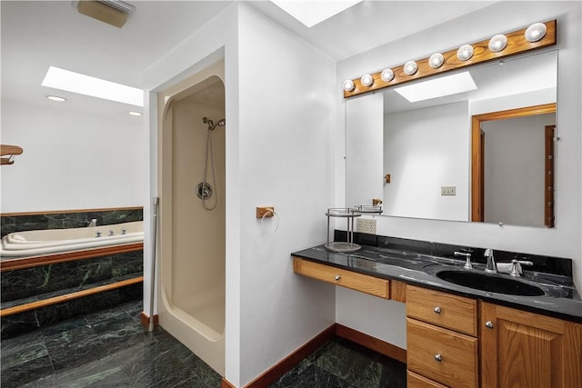 full bathroom featuring a skylight, marble finish floor, vanity, baseboards, and walk in shower