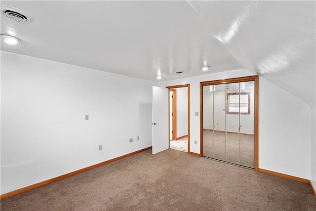 additional living space featuring lofted ceiling, carpet flooring, visible vents, and baseboards