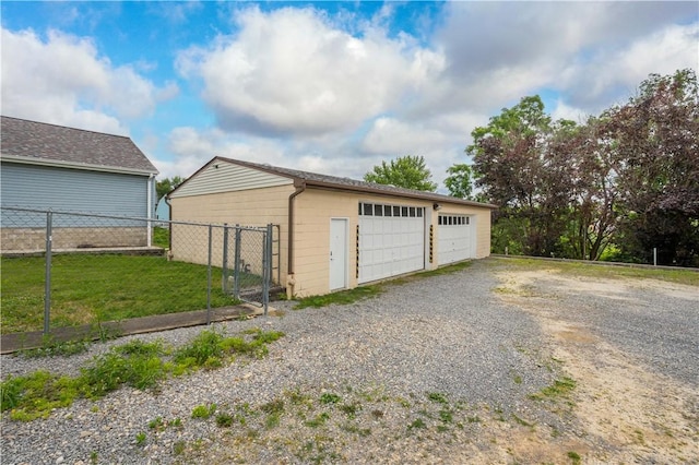 detached garage featuring fence