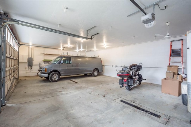 garage with a garage door opener and electric panel