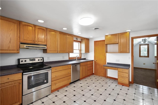 kitchen featuring appliances with stainless steel finishes, dark countertops, exhaust hood, and visible vents