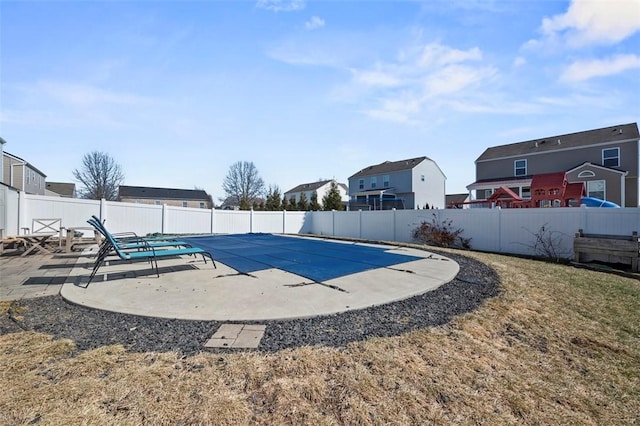 view of swimming pool featuring a patio area, a fenced backyard, and a fenced in pool