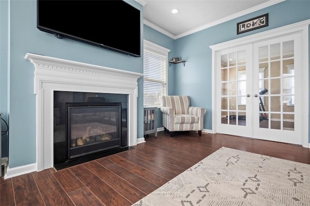 unfurnished room with french doors, crown molding, a glass covered fireplace, wood finished floors, and baseboards