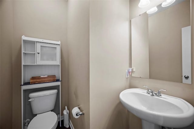 bathroom with toilet and a sink