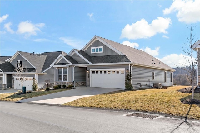 craftsman-style home with a shingled roof, board and batten siding, a front yard, a garage, and driveway