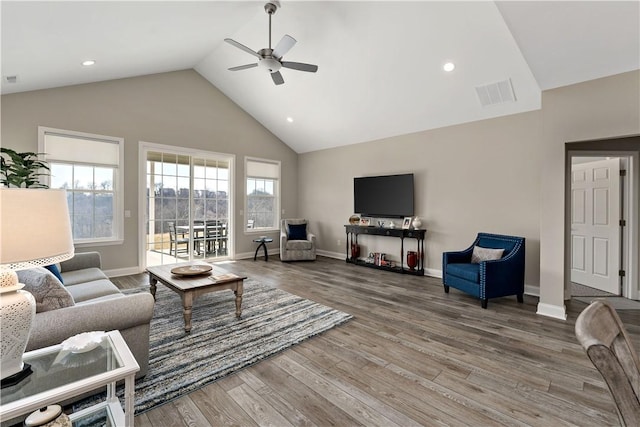 living room featuring visible vents, a ceiling fan, wood finished floors, high vaulted ceiling, and baseboards