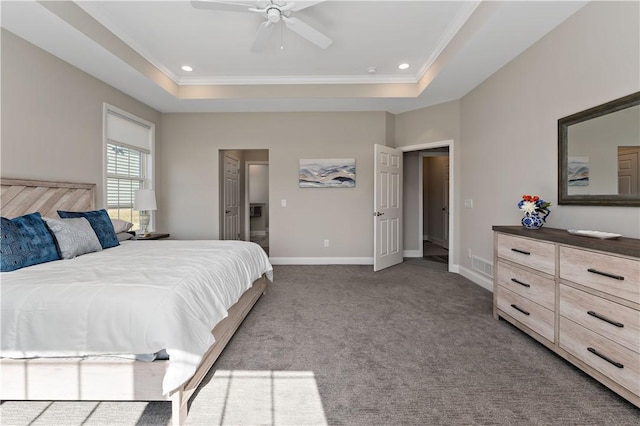 carpeted bedroom featuring a tray ceiling, visible vents, and baseboards