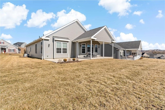 rear view of property with a patio area and a yard