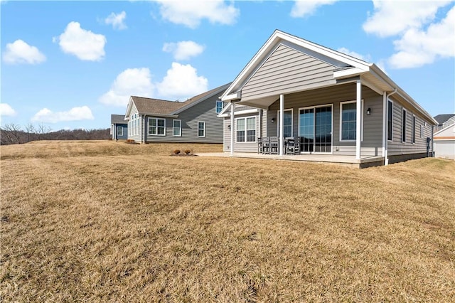 rear view of property featuring a yard