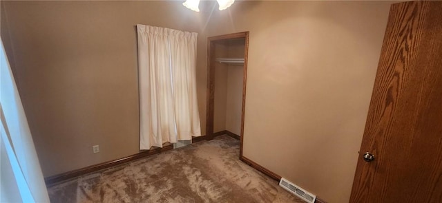 unfurnished bedroom featuring baseboards, visible vents, and carpet flooring