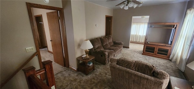 carpeted living area featuring a ceiling fan