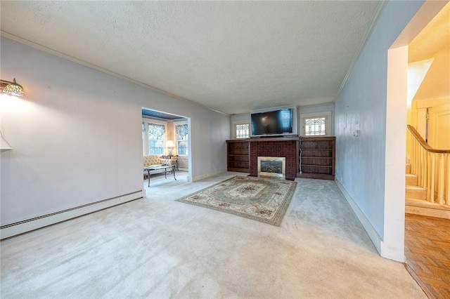 unfurnished living room featuring a healthy amount of sunlight, a brick fireplace, stairway, and ornamental molding