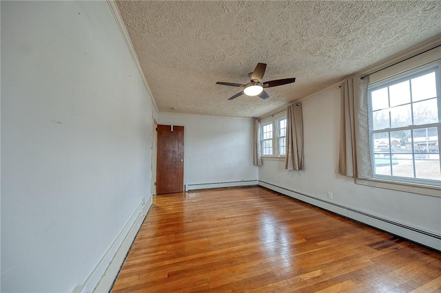 unfurnished room with light wood-style floors, a baseboard radiator, ceiling fan, and a textured ceiling