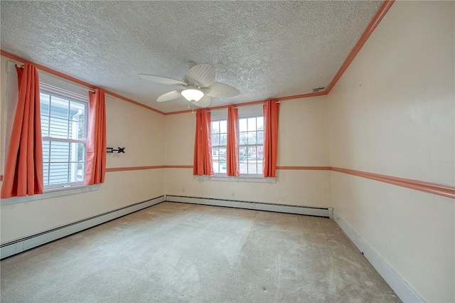 carpeted spare room featuring ornamental molding, ceiling fan, a textured ceiling, and baseboards