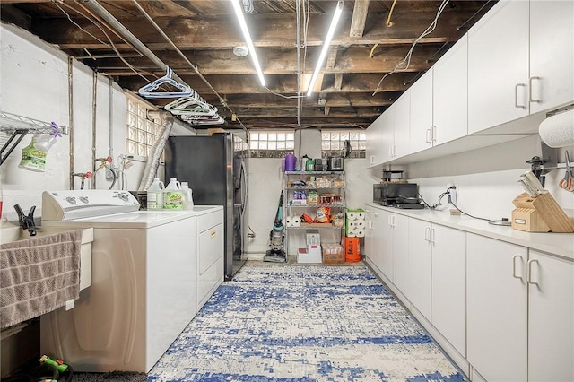 clothes washing area with cabinet space and washer and dryer