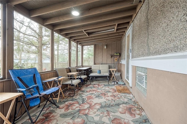 sunroom / solarium featuring beam ceiling