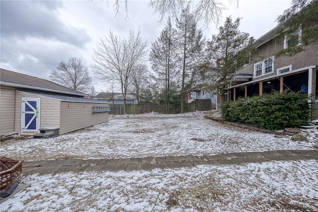 snowy yard with fence