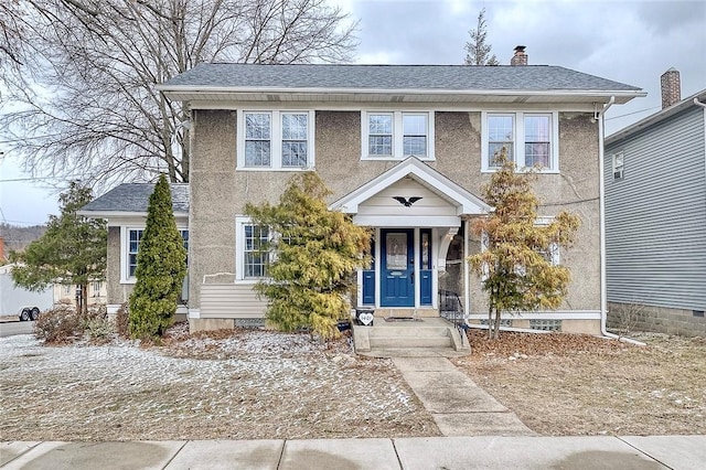 view of front of home with a shingled roof, crawl space, a chimney, and stucco siding