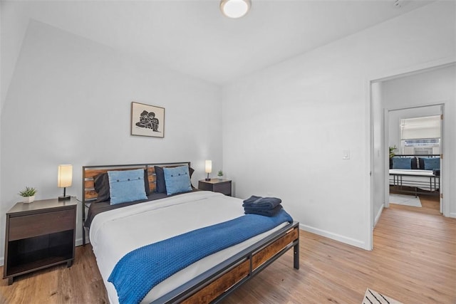 bedroom featuring light wood-style flooring and baseboards