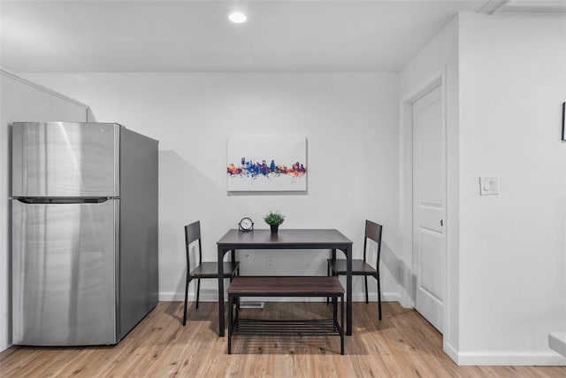 dining room featuring baseboards, recessed lighting, and light wood-style floors