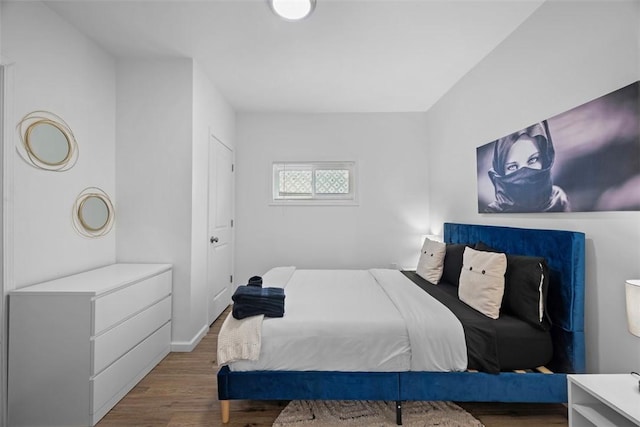 bedroom with wood finished floors